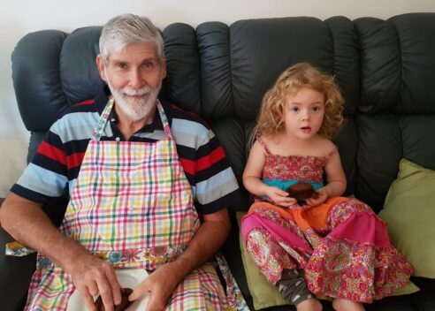 Dementia real care stories Bob and grand daughter sitting on couch